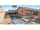 Backyard pool area features an in-ground pool, covered outdoor entertaining area, and lounge chairs for relaxing by the water at 868 Marina Dr, Boulder City, NV 89005