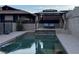 Backyard features an in-ground pool with covered lounge area with steps up to outdoor seating and relaxing pool views at 868 Marina Dr, Boulder City, NV 89005