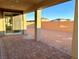 Covered patio and spacious backyard with a large grassy area at 9813 Belikove Manor Ave, Las Vegas, NV 89178