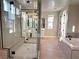 Modern bathroom with a frameless glass shower and a free-standing bathtub at 9813 Belikove Manor Ave, Las Vegas, NV 89178