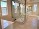 Spa-like bathroom with a large glass shower, soaking tub, and modern vanity at 9813 Belikove Manor Ave, Las Vegas, NV 89178