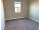 Simple bedroom with large window and neutral decor at 9813 Belikove Manor Ave, Las Vegas, NV 89178