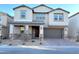 Two-story house with stone accents and a brown garage door at 9813 Belikove Manor Ave, Las Vegas, NV 89178