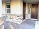 Front entry with stonework and a dark brown door at 9813 Belikove Manor Ave, Las Vegas, NV 89178