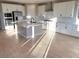 Open concept kitchen with island and stainless steel appliances at 9813 Belikove Manor Ave, Las Vegas, NV 89178