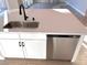 Kitchen island with sink, dishwasher, and white cabinets at 9813 Belikove Manor Ave, Las Vegas, NV 89178