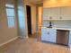 Small kitchenette with white cabinets and stainless steel appliances at 9813 Belikove Manor Ave, Las Vegas, NV 89178