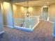 Bright upstairs hallway with chandelier and white railings at 9813 Belikove Manor Ave, Las Vegas, NV 89178