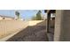 View of the backyard from the patio which includes desert landscaping and a block fence at 1013 Adobe Flat Dr, Henderson, NV 89011