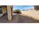 View of the gravel and dirt backyard with brick wall at 1013 Adobe Flat Dr, Henderson, NV 89011