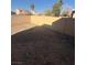Image shows the flat, empty backyard with block fencing at 1013 Adobe Flat Dr, Henderson, NV 89011