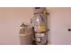 Image shows a water heater and water treatment system in the garage at 1013 Adobe Flat Dr, Henderson, NV 89011