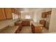Spacious kitchen layout with brown cabinets, and an island at 1013 Adobe Flat Dr, Henderson, NV 89011
