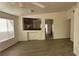 Living room with wood-look floors and kitchen view at 1013 Adobe Flat Dr, Henderson, NV 89011