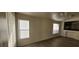 Bright living room with wood-look floors and kitchen view at 1013 Adobe Flat Dr, Henderson, NV 89011