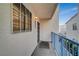 Cozy balcony featuring a textured exterior wall, large window, and a blue railing offering outdoor living space at 2725 S Nellis Blvd # 2108, Las Vegas, NV 89121