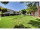Manicured community bocce ball court on lush green lawn with trees and landscaping, perfect for outdoor recreation at 2725 S Nellis Blvd # 2108, Las Vegas, NV 89121