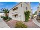 Exterior shot of a condo building with white facade, blue accents, and desert landscaping at 2725 S Nellis Blvd # 2108, Las Vegas, NV 89121