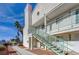 Building exterior showing blue railings, stairs, palm trees, and a well-maintained walkway at 2725 S Nellis Blvd # 2108, Las Vegas, NV 89121