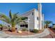 Condo building with a stucco finish, desert landscaping, a chimney, and blue design accents at 2725 S Nellis Blvd # 2108, Las Vegas, NV 89121