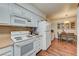 Well-lit kitchen with white appliances and a dining area, creating a cozy and functional space at 2725 S Nellis Blvd # 2108, Las Vegas, NV 89121