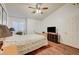 Bright main bedroom with wood floors, a ceiling fan, and a large window with blinds at 2725 S Nellis Blvd # 2108, Las Vegas, NV 89121
