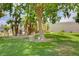 Lush community park area with mature trees and seating, perfect for relaxation and enjoying nature at 2725 S Nellis Blvd # 2108, Las Vegas, NV 89121