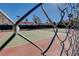 Fenced community tennis court with green and red surface, perfect for tennis enthusiasts and recreational play at 2725 S Nellis Blvd # 2108, Las Vegas, NV 89121