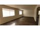 Living room with wood-look floors and large windows at 6232 Blair Way, Las Vegas, NV 89107