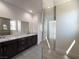 Contemporary bathroom showcasing a double vanity and glass-enclosed shower at 10208 Bismarck Palms Ave, Las Vegas, NV 89166