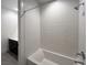 Bathroom with shower and bath combo featuring sleek tiles at 10208 Bismarck Palms Ave, Las Vegas, NV 89166