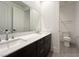 Bathroom featuring double sinks, modern fixtures, and sleek tile flooring at 10208 Bismarck Palms Ave, Las Vegas, NV 89166