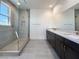 Modern bathroom with glass shower, dual vanity, and sleek tile flooring at 10208 Bismarck Palms Ave, Las Vegas, NV 89166