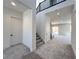 Open entryway with carpet, stairs, and a view of the open-concept kitchen and living space at 10208 Bismarck Palms Ave, Las Vegas, NV 89166