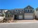 Beautiful two-story home featuring a three car garage and a welcoming, landscaped front yard at 10208 Bismarck Palms Ave, Las Vegas, NV 89166