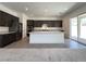 Modern kitchen with a large island, stainless steel appliances, and dark wood cabinets at 10208 Bismarck Palms Ave, Las Vegas, NV 89166