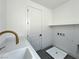 Bright laundry room with a modern quartz countertop, matte gold faucet, and plenty of storage space at 10208 Bismarck Palms Ave, Las Vegas, NV 89166