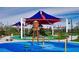 A colorful and shaded playground with water features offers a fun and safe environment for children to play at 10208 Bismarck Palms Ave, Las Vegas, NV 89166