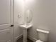 This powder room has a white pedestal sink, an oval mirror, and a toilet at 10208 Bismarck Palms Ave, Las Vegas, NV 89166