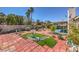 Spacious backyard featuring brick patios, desert landscaping, and mature trees at 4357 Valley Regal Way, North Las Vegas, NV 89032