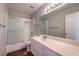 Bright bathroom with a shower-tub combo and a large mirror over the white vanity at 4357 Valley Regal Way, North Las Vegas, NV 89032