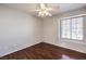 The bedroom has hardwood floors, a ceiling fan and a window providing natural light at 4357 Valley Regal Way, North Las Vegas, NV 89032