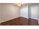 This bedroom features wood floors, a closet, and neutral walls at 4357 Valley Regal Way, North Las Vegas, NV 89032