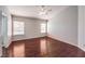 This bedroom features wood floors, neutral walls, and a ceiling fan at 4357 Valley Regal Way, North Las Vegas, NV 89032
