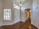 Bright foyer featuring hardwood floors, a front door with transom window, and an arched doorway at 4357 Valley Regal Way, North Las Vegas, NV 89032
