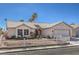 Inviting single-story home boasting desert landscaping, a white picket fence, and a well-maintained front yard at 4357 Valley Regal Way, North Las Vegas, NV 89032