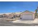 Well-maintained single-story house with a two-car garage, desert landscaping, and a charming white picket fence at 4357 Valley Regal Way, North Las Vegas, NV 89032