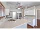 Bright kitchen with quartz countertops, white cabinets, and stainless steel appliances at 4357 Valley Regal Way, North Las Vegas, NV 89032
