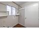 Convenient laundry room with overhead shelving and a utility sink hookup at 4357 Valley Regal Way, North Las Vegas, NV 89032