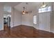 Open-concept living area with hardwood floors, natural light, and an archway to the kitchen at 4357 Valley Regal Way, North Las Vegas, NV 89032